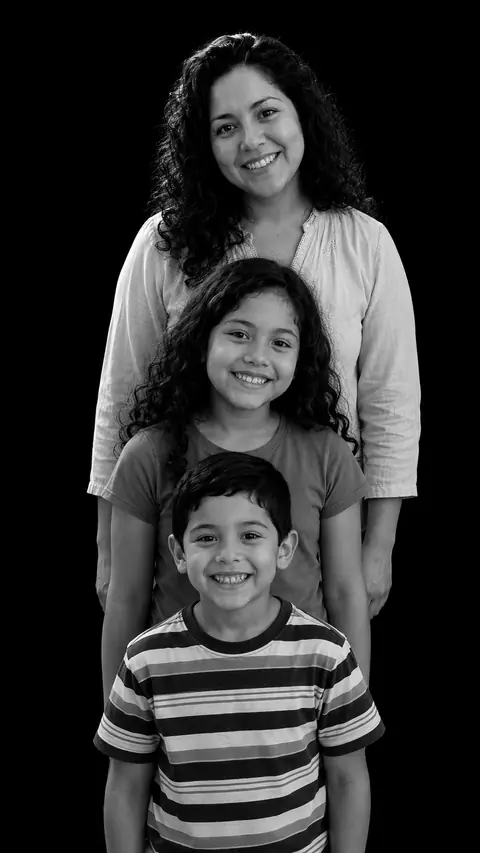 A mother and two children in a stacked monochrome studio portrait: a woman with long curly hair, a girl with curls to her shoulders, and a boy in a striped T-shirt